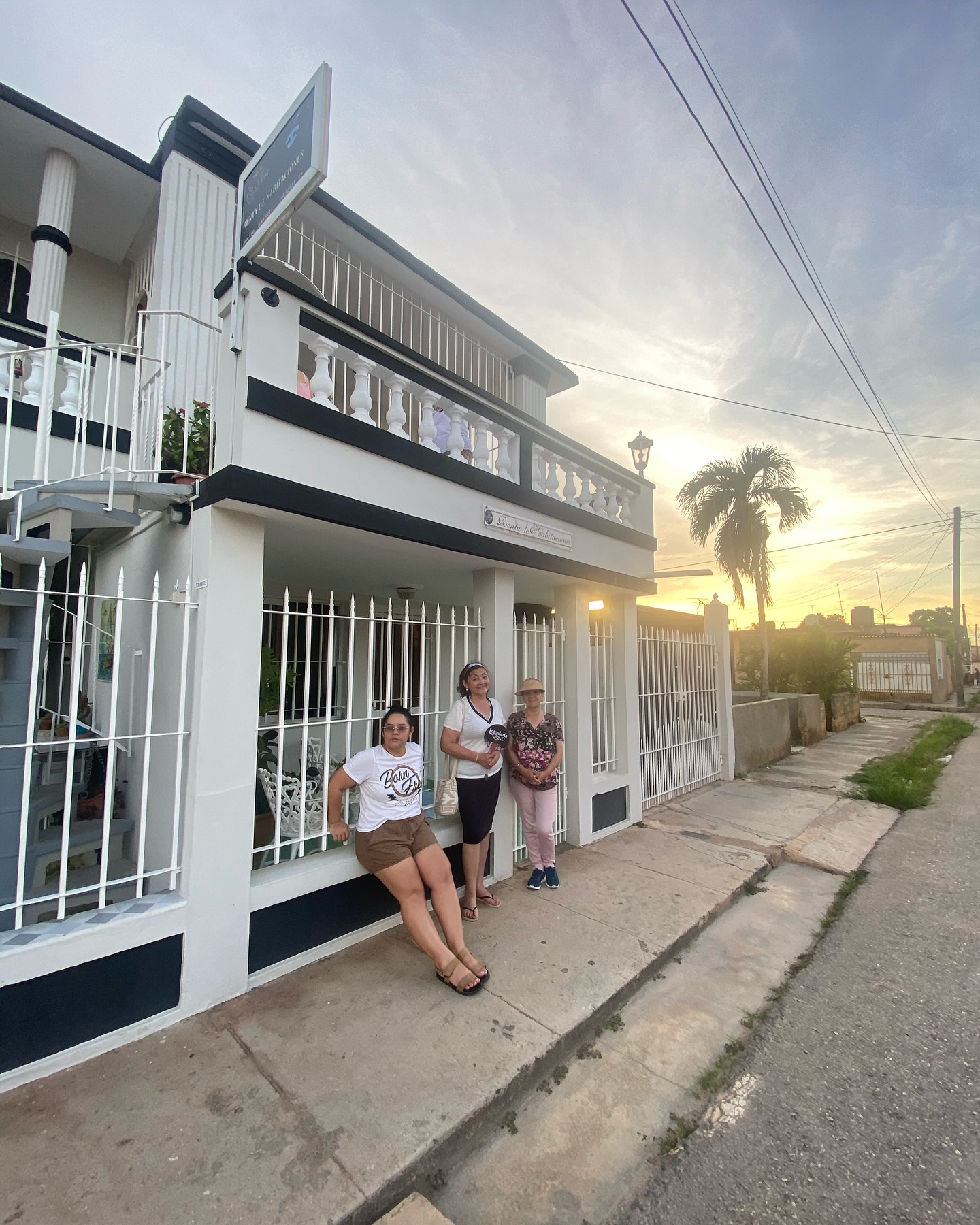 The two-storey Republican facade of Hostal Jose Cuba at dusk in Cárdenas, with soft pastel sky